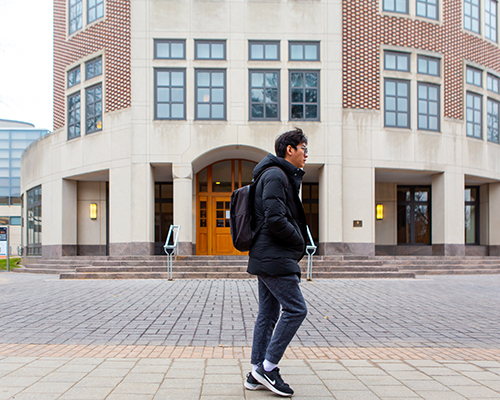 student walking in front of the computer science building