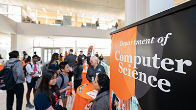 students at advising fair with a CS dept banner