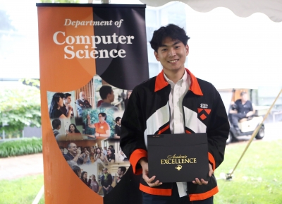 Photo of Alex Zhang holding his award