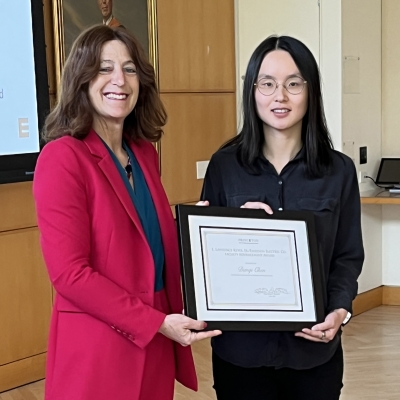 Andrea Goldsmith presenting the framed award to Danqi Chen