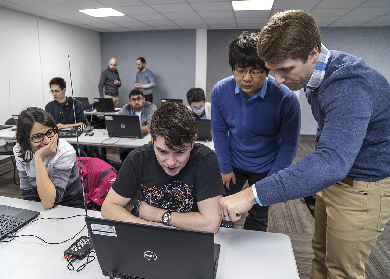 Graduate students Mina Arashloo and Robert McDavid in the COS 463 Wireless Networks software-defined radio laboratory, where students are learning how to build real-world wireless networks from signals, to bits, to packets.