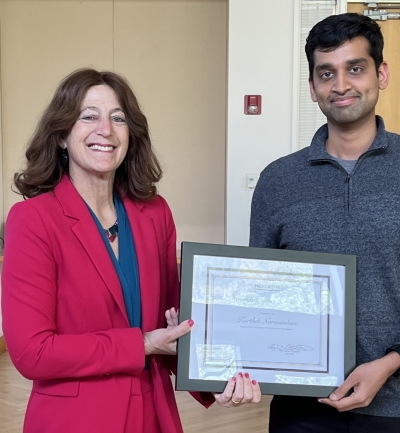 Andrea Goldsmith presenting the framed award to Karthik Narasimhan