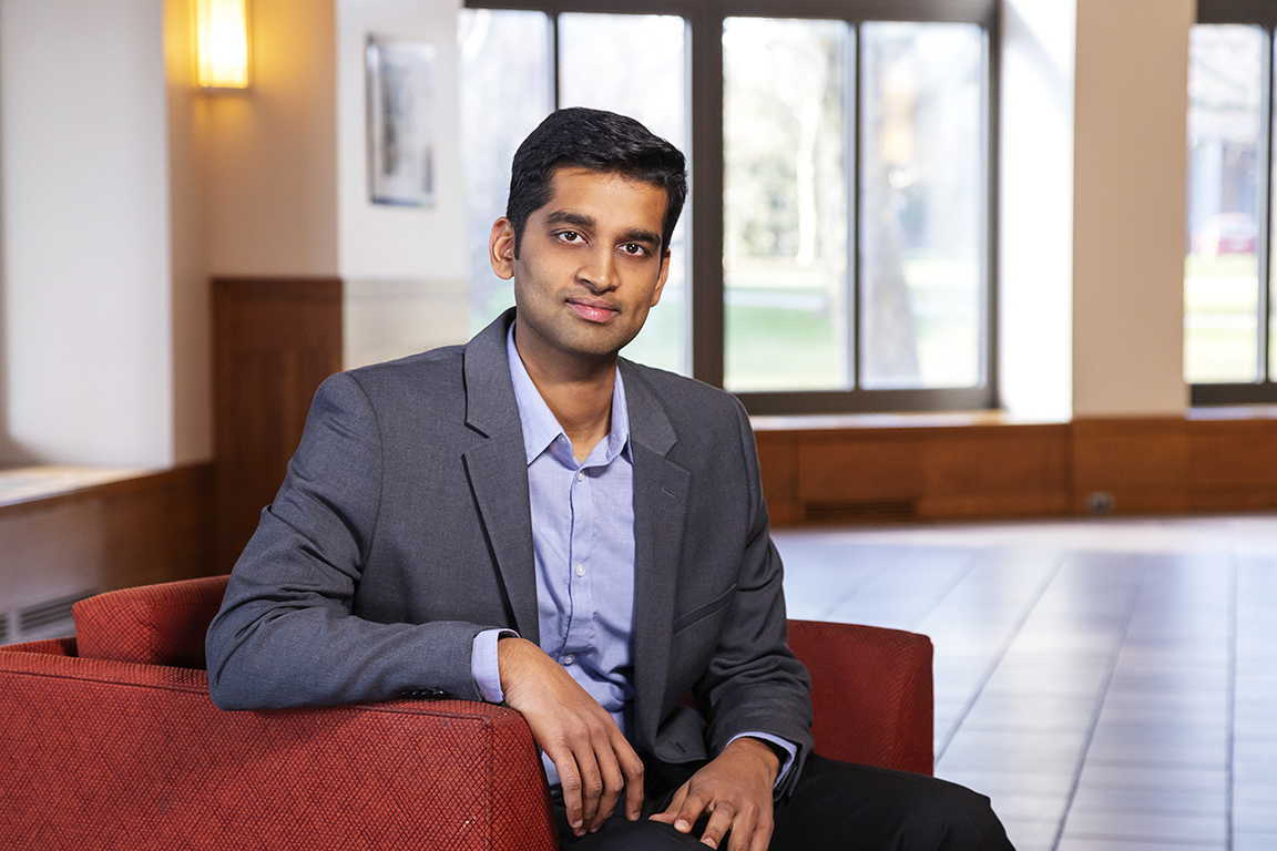 Karthik Narasimhan sitting in a red chair